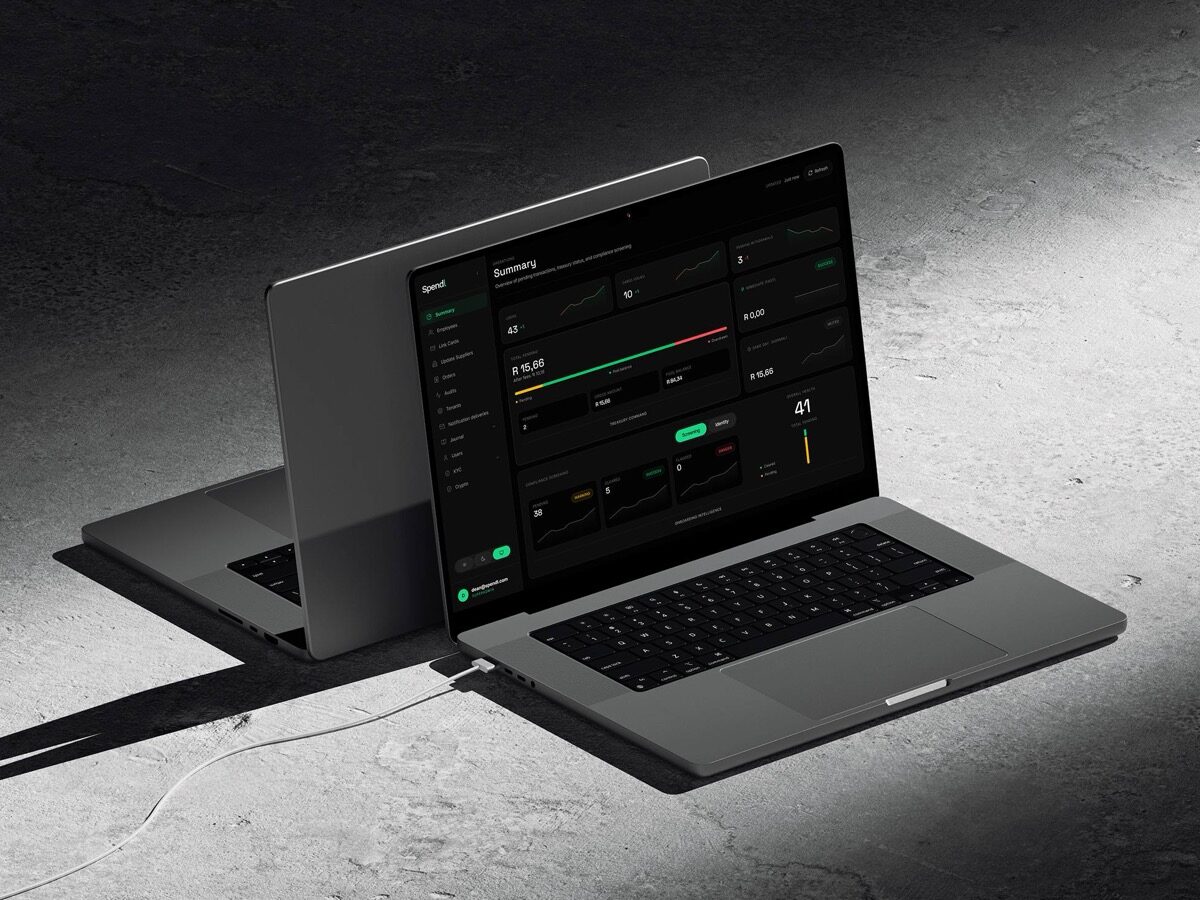 Spendl administration console displayed across two laptops